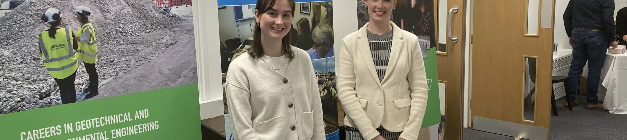 Two women in front of a careers stand